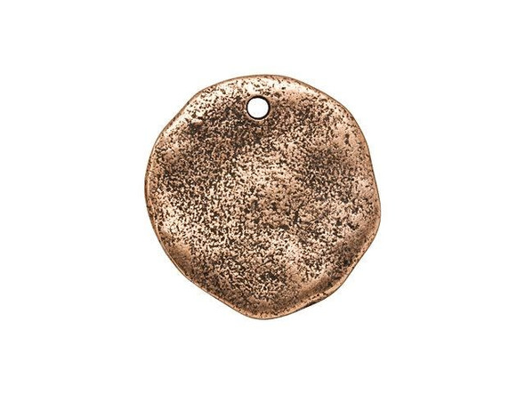 Give your designs an artisan look with this Nunn Design charm. This tag charm features an irregular circle shape with an organic texture. The models for this flat tag were formed by hand, so each one has a beautiful handmade look with an irregular surface. You can showcase this charm as-is or create metal stamped designs, embellish with crystals or epoxy clay, and more. Use the hole at the top of the tag to add this piece to necklaces, bracelets, and even earrings. This charm features a warm copper glow you'll love.