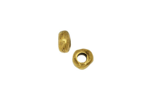 This Nunn Design bead makes the perfect spacer in jewelry designs. This small bead features an organic nugget-like shape with irregular edges. The thin shape is perfect for using between larger beads or you can layer several together. The wider stringing hole is ideal for using with leather. Stock up on this little bead and add it to all kinds of projects - necklaces, bracelets, earrings, and more