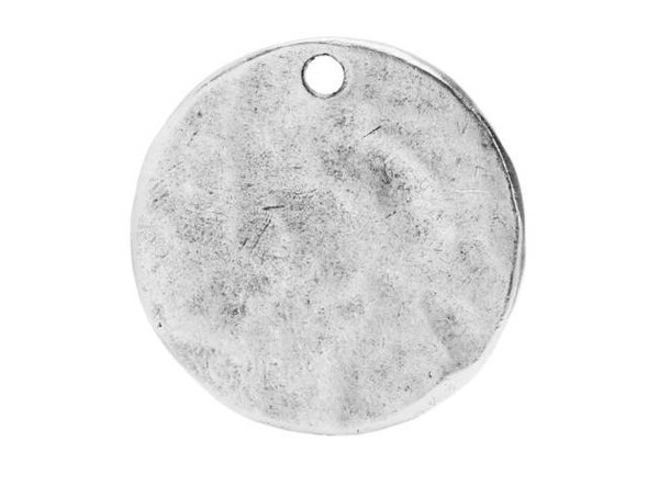 Display unique style in your designs with the Nunn Design antique silver-plated pewter mini hammered flat small circle tag charm. This flat circular charm features a stringing hole drilled through the top, so it's easy to add to designs. It is versatile in size and would look good as a pendant in a necklace or in bold, dangling earrings. Use metal stamping for a personalized look. The hammered texture adds an interesting look to designs. This charm features a versatile silver color. Diameter 21mm, Hole Size 1.6mm/14 gauge