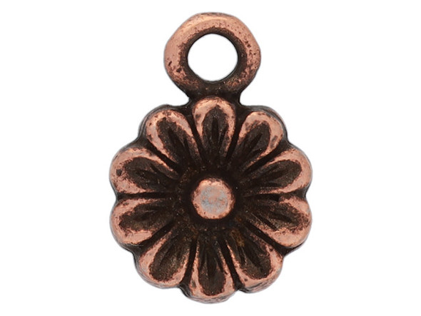 Bring floral style to your designs with this itsy aster flower charm from Nunn Design. This charm is shaped like a flower with petals radiating from its center. The edges of the petals and the center of the flower is raised. This charm has a copper color with dark tones in the recessed areas of the design.