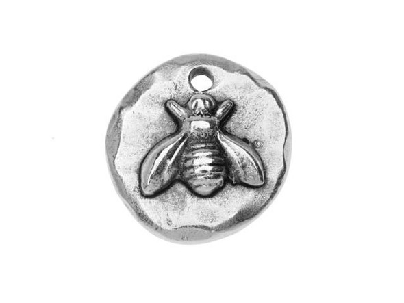 Put a cute accent on your style with this Nunn Design charm. This charm is circular in shape and the front is decorated with a raised design of a sweet bumblebee. The back of the charm is plain and flat. You'll love the high-quality artisan style of this piece. A small hole at the top of the charm makes it easy to add to your necklaces, bracelets, and earrings. This charm displays a versatile silver shine, so you can easily use it with any color palette.