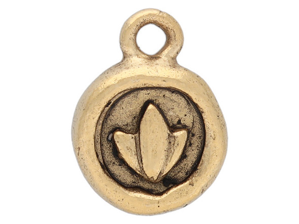 Add a meaningful detail to your designs with this itsy circle lotus charm from Nunn Design. This small charm is circular in shape and the front features a raised design of a lotus blossom. The back is plain. The lotus is a symbol of purity and enlightenment, meant to represent life and new beginnings. This charm features a golden color with dark tones in the recesses of the design.