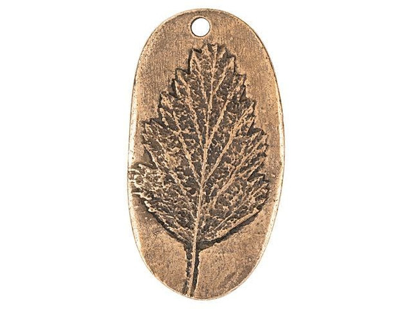 Add nature's beauty to your jewelry designs with this Nunn Design charm. This charm takes on an oval shape and the front features a raised design of an Alder leaf. The leaf is full of beautiful details that will draw the eye to your jewelry designs. Use the hole at the top of the charm to easily dangle it from necklaces and even earrings. It will make a wonderful showcase in any project. The back of the charm is flat and features an impression of the design on the front.