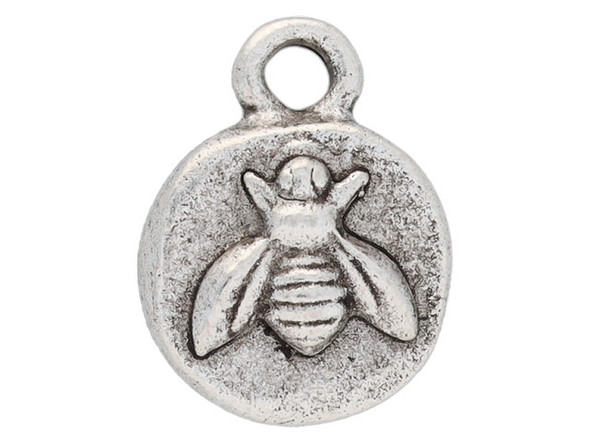 Bring some buzz to your designs with this itsy organic bee charm from Nunn Design. This small charm has a circular shape and features a raised design of a bee.  The back is plain. This charm has an antique silver color.