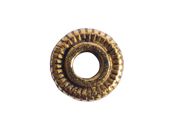 Intricate detail fills this line edge spacer bead from Nunn Design. This spacer features a traditional O shape. The outside of the bead features etched lines that create an interesting pattern around the edge of the bead. This bead features a classic golden shine. Dimensions: 6 x 1.5mm, Hole Size: 2.0mm