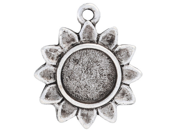 Floral style fills this itsy bezel sunflower pendant from Nunn Design. This pendant is shaped like a sunflower. The center of the flower is a round bezel with a flat bottom.  It would work well with resin or epoxy clay. There is a loop at the top of the pendant, so it is easy to add it to your designs. This pendant features an antique silver color. Bezel Dimensions: Inner Diameter 9.3mm, Depth 1mm