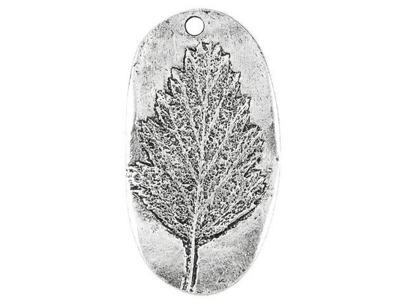 Add nature's beauty to your jewelry designs with this Nunn Design charm. This charm takes on an oval shape and the front features a raised design of an Alder leaf. The leaf is full of beautiful details that will draw the eye to your jewelry designs. Use the hole at the top of the charm to easily dangle it from necklaces and even earrings. It will make a wonderful showcase in any project. The back of the charm is flat and features an impression of the design on the front.