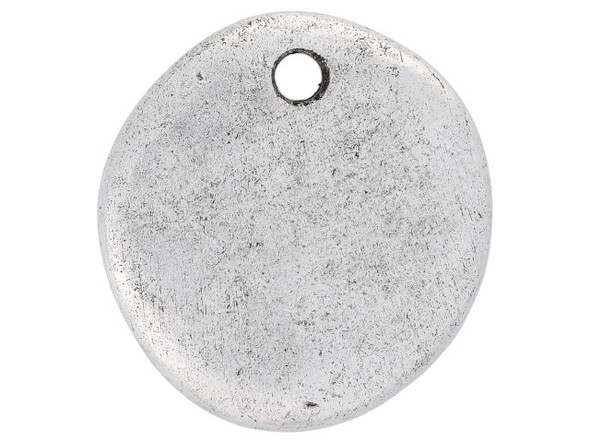 Put a lovely accent into your style with this Nunn Design charm. This charm is circular in shape, giving you a classic piece to work with. The front surface features a textured dimension, for a handmade, artisan look. The back of this charm is flat. Display this charm as it is in your designs, or customize it with metal stamping or by adding epoxy clay, resin, and more. The hole at the top of this charm makes it easy to add to designs. Use it in necklaces, bracelets, and even earrings. It features a versatile silver color. Hole Size 2mm/12 gauge, Length 18.5mm, Width 17.5mm