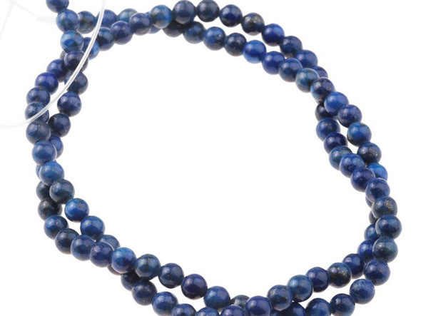 Dark elegance fills these lapis lazuli round beads from Dakota Stones. Available by the strand, these bold beads are spherical in shape and feature glittering golden color sprinkled over a dark blue background. Lapis lazuli is a semi-precious stone that contains primarily lazurite, calcite and pyrite. It was among the first gemstones to be worn as jewelry. Showcase these stunning gemstone beads in your next design. Metaphysical Properties: Lapis lazuli is said to enhance insight, intellect and awareness. Because gemstones are natural materials, appearances may vary from bead to bead.