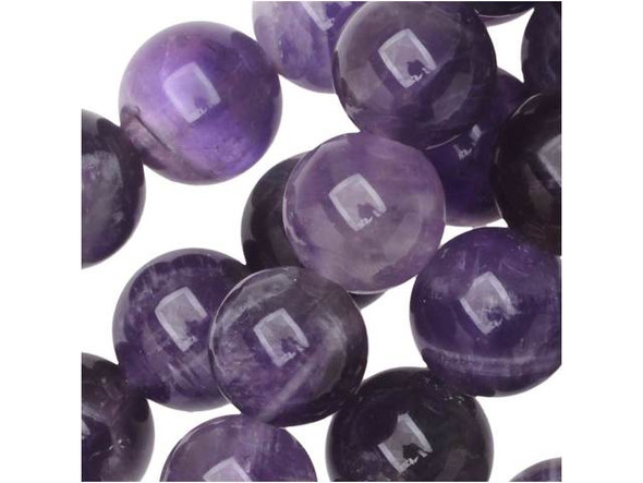 Keep your looks soft and sophisticated with these Dakota Stones dog teeth amethyst beads. These beads feature beautiful hues of purple mixed with cloudy whites. These beads feature a spherical shape and a versatile size that works in bracelets and necklaces. Use these beads with silver tones for an elegant look. Mined in Africa, dog teeth amethyst is a combination of amethyst and white quartz mixed together in a striped, chevron pattern. It is named for its resemblance to the dog tooth violet. This stone is also known as chevron amethyst. Metaphysical Properties: Dog teeth amethyst is said to help remove resistance to change and to dissipate and repel negativity of all kinds.Because gemstones are natural materials, appearances may vary from bead to bead. Each strand includes approximately 24 beads. Our amethyst beads have nice, deep color, but may show natural inclusions.