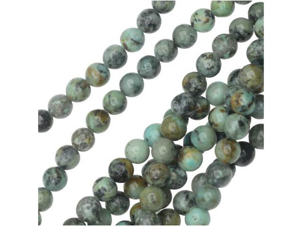 Delight in the unique colors of the Dakota Stones 6mm African Turquoise Jasper round beads. Available by the strand, these beads feature a perfectly round shape. They are versatile in size, so you can use them anywhere. Each bead features turquoise blue color with a black matrix. This stone is mined in Africa and is actually a type of spotted teal Jasper rather than turquoise. It is given its industry name because the matrix structure and shade is similar to that of turquoise. It has a Mohs hardness of 6. Metaphysical Properties: Often called the stone of evolution, African Turquoise Jasper encourages growth and development not only in the body, but in the mind. Some spiritualists believe that it will attract money to the wearer.Because gemstones are natural materials, appearances may vary from piece to piece. Each strand includes approximately 34 beads. 