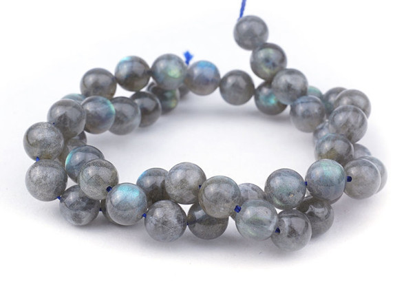 Bring the shimmer of Labradorite to your designs with these 8mm round gemstone beads from Dakota Stones. These round beads emit blue and purple fire when the light hits them. Labradorite is named for Labrador Island in Canada, where it was first discovered. Add these beads to your designs for unique color that will turn heads. Metaphysical Properties: Labradorite is said to detoxify the body and slow the aging process. Because gemstones are natural materials, appearances may vary from bead to bead. 