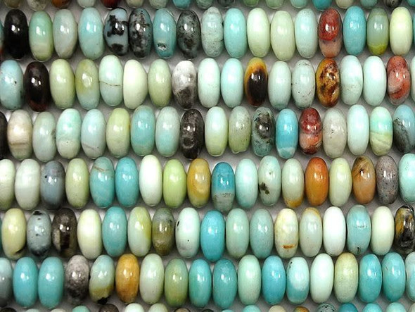 Soothing colors fill the Dakota Stones 10mm black gold Amazonite large-hole roundel beads. Available by the strand, these gemstone beads will amaze and delight with their innovative design. Each bead features a wide stringing hole, perfect for using with thicker stringing materials like leather cord. These beads display a rounded shape and a bold size. They are sure to stand out in designs. They display beautiful sandy neutral colors, ocean blues, and hints of pale green, cream and even black. Black gold Amazonite contains Amazonite, Tourmaline and pyrite all in one light blue and black stone. Metaphysical Properties: Black gold Amazonite is often used to become a better communicator. It is also said to stop fearful feelings during confrontation or when reflecting on painful memories.Because gemstones are natural materials, appearances may vary from piece to piece. Each strand includes approximately 20 beads.Diameter 10mm, Hole Size 2.5mm/14 gauge