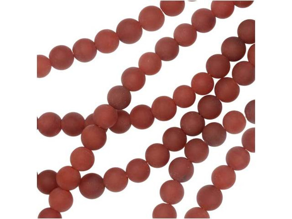 Glowing warmth radiates from the matte carnelian 6mm round beads from Dakota Stones. Available by the strand, these beads feature a perfectly round shape and a versatile size, alive with soft red color and hints of orange. These beads feature the perfect size for necklaces, bracelets and even earrings. Carnelian is a translucent chalcedony or an A-grade agate that receives its beautiful red tints from iron oxides. Most deep red carnelian is heat treated to darken the material evenly; these have been sandblasted to give them a matte finish. Carnelian is also known as the Mecca stone and natural agate. It has a Mohs hardness of 6.5. Metaphysical Properties: Often known as a motivation stone, carnelian is used for physical training and balancing body energy levels.Because gemstones are natural materials, appearances may vary from bead to bead. Carnelian is heat-treated to have a consistent color across the bead and strand. The color is very consistent. Each strand includes approximately 34 beads.