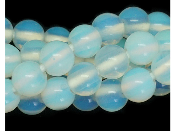 Add gemstone style to your next design with these beads from Dakota stones. These beads are perfectly round in shape and feature a versatile size that you can use in all kinds of designs. These beads would look wonderful in matching necklace and bracelet sets. Their large stringing hole makes these beads great for use with thicker stringing materials. Opalite is the trade name for man made glass treated to exhibit the internal flashes of true Opals in translucent samples, and opalescence or lustrous sheen in opaque samples. Opalite can have a blue appearance when placed against a dark background and appear milky white with a pink or orange glow against a light background. Opalite is known by several other names, including Moonstone. Because gemstones are natural materials, appearances may vary from bead to bead.