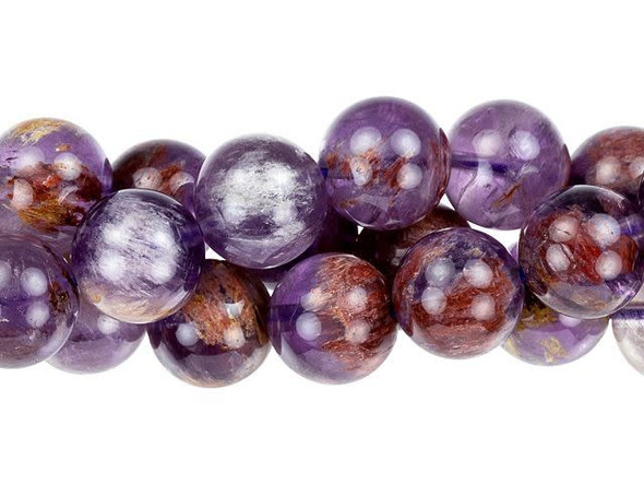 Cacoxenite is the trade name for this naturally occurring blend of seven stone types. This stone, often called the "Super Seven" or "Melody Stone" contains amethyst, clear quartz, smoky quartz, lepidocrosite, goethite, and rutile. Showcase these large round beads in your jewelry designs. You'll love the smoky purple and brown colors. Metaphysical Properties: Cacoxenite is said to be a healing and harmonizing stone. Because gemstones are natural materials, appearances may vary from bead to bead. Each strand includes approximately 32 beads.