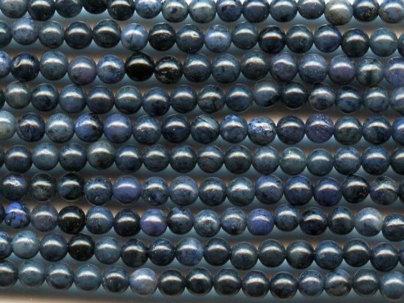 Give your designs a touch of regal color using the dumortierite 4mm round beads from Dakota Stones. These beads feature deep blue color that looks good with creamy neutrals and bold gold tones, too. Their tiny size makes them perfect for using as accents of color for all kinds of designs. Dumortierite is a fibrous variably colored aluminum boro-silicate mineral. They crystals are vitreous and vary in color. Metaphysical Properties: Known as the "Stone of Order," dumortierite is said to help boost intellectual perception and to help in becoming more organized.Because gemstones are natural materials, appearances may vary from piece to piece. Each strand includes approximately 52 beads.