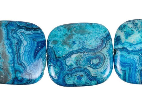 Create fun focal pieces with these Dakota Stones blue crazy lace agate beads. These square-shaped beads are large in size, so you can string them onto a head pin to turn them into pendants or use them in wire wrapping and bead embroidery projects. Each bead features beautiful blue patterns that look like rippling water. Mexican crazy lace agate is normally an opaque white gemstone with swirling patterns, but these beads are color enhanced with blue coloring to emphasize these beautiful patterns. Color enhancing is common amongst agates to make them fashionably relevant. They have a Mohs hardness of 6.5-7. Metaphysical Properties: Often called the happy stone, crazy lace agate promotes laughter and optimism. Because gemstones are natural materials, appearances may vary from piece to piece. Each strand includes approximately 7 beads.