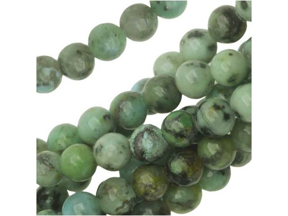 Add stony color to designs with the Dakota Stones 4mm African Turquoise Jasper round beads. Available by the strand, these beads feature a perfectly round shape. They are small in size, so you can use them as spacers or as pops of color in earrings. Each bead features turquoise blue color with a black matrix. This stone is mined in Africa and is actually a type of spotted teal Jasper rather than turquoise. Some believe that African Turquoise will attract money to the wearer, so it can't hurt to add it to your designs.Because gemstones are natural materials, appearances may vary from piece to piece. Each strand includes approximately 52 beads.