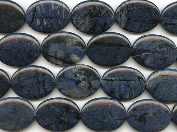 Create a bold focal for your designs with the help of these dumortierite 30x40mm oval beads from Dakota Stones. These large beads are oval in shape and feature dark blue color decorated with streaks of black and white. Use them as pendants in dramatic necklace designs. Dumortierite is a fibrous variably colored aluminum boro-silicate mineral. They crystals are vitreous and vary in color. Metaphysical Properties: Known as the "Stone of Order," dumortierite is said to help boost intellectual perception and to help in becoming more organized.Because gemstones are natural materials, appearances may vary from piece to piece. Each strand includes approximately 5 beads. 