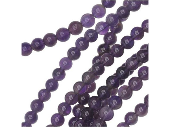 Add the sophistication of natural beauty to your looks with the Dakota Stones amethyst 6mm round beads. Available by the strand, these beads are spherical in shape and are full of deep purple color, accented with the occasional streak of cloudy white. These beads feature a versatile size that can be used in necklaces, earrings and bracelets. Amethyst is the official birthstone of February. It forms in silica-rich liquids deposited in geodes and is generally found in clusters of crystal points. Metaphysical Properties: This stone's name is derived from the Greek word amethystos, meaning "not drunken." People of ancient times believed it to protect the wearer from drunkenness. Today, this gemstone is believed to promote happiness.Because gemstones are natural materials, appearances may vary from piece to piece. Each strand includes approximately 34 beads. Our amethyst beads have nice, deep color, but may show natural inclusions.