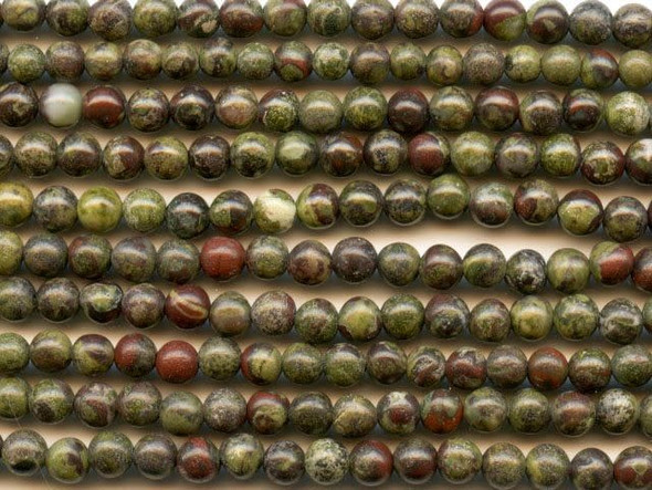 Forest green mixes with spatters of blood red color in the dragon blood jasper 4mm round beads from Dakota Stones. These small beads feature perfectly round shape and deep green color with a crimson red matrix. The two primary colors contrast and complement each other to form a striking jasper. This gemstone is mined in Australia. These beads would make perfect spacers and would look beautiful with copper components. Dragon blood jasper is part of the quartz family. Metaphysical Properties: Dragon blood jasper enhances courage, strength and vitality.Because gemstones are natural materials, appearances may vary from bead to bead. Each strand includes approximately 52 beads.