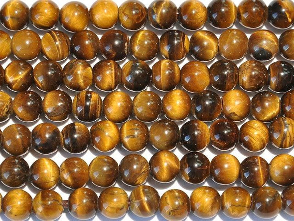 For a mystical gleam in your designs, try the tiger eye 8mm large-hole round beads from Dakota Stones. Available by the strand, these gemstone beads will amaze and delight with their innovative design. Each bead features a wide stringing hole, perfect for using with thicker stringing materials like leather cord. In fact, these beads are temporarily strung on leather cord. These perfectly round beads feature dark golden brown color with reflective bands of light dancing on the surface. Tiger eye is a variety of quartz which is chatoyant because of parallel intergrowth of quartz crystals and altered amphibole fibers that mostly turn to limonite. Metaphysical Properties: Tiger eye can be used to balance pessimistic behavior and it dissolves negative energy and though patterns. This "all-seeing stone" allows perspective on any situation and it can help gently attune the Third Eye. It is said to enhance psychic abilities, such as clairvoyance. It has also been used to enhance wealth and vitality.Because gemstones are natural materials, appearances may vary from bead to bead. Each strand includes approximately 24 beads.