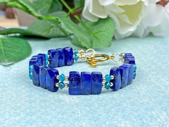 For colorful elegance in your designs, try these lapis beads from Dakota Stones. These beads feature a rectangular shape with two stringing holes. They are versatile in size, so you can add them to multi-strand looks, use them as cute watch bands, and more. These gemstone beads feature the rich blue color lapis is known for. Lapis is a semi-precious stone that was among the first gemstones to be worn as jewelry. Metaphysical Properties: Lapis is said to enhance insight, intellect and awareness.Because gemstones are natural materials, appearances may vary from piece to piece. Each strand includes approximately 40 beads.