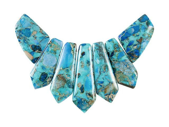 For truly eye-catching style, try this Dakota Stones pendant set. This pendant set includes seven bold and pointed gemstone drop beads in graduated sizes you can easily use in stringing projects. Slide them all together in designs or use them separately. They would even make beautiful elements in bead embroidery. These beads combine blue Impression Jasper and turquoise, for a vibrant look filled with swirling blue colors and a stony matrix. Please note that these beads are made from composite gemstones. Because gemstones are natural materials, appearances may vary from piece to piece. Length 25-45.5mm, Width 15.5-25mm (Longest bead is a little over 1 3/4")