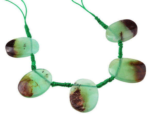 This Australian Chrysoprase is from the DS Premier line. This limited edition strand is specialty cut from &ldquo;gem quality&rdquo; grade Chyrsoprase.  They left parts of the host rock that Chrysoprase forms in to provide the brown contrast to the transparent green of the A-grade Chrysoprase. This brown and green contrast is sometimes referred to as Boulder Chrysoprase. Chrysoprase is a bright apple green, translucent stone, whose color often caused ancient jewelers to confuse it with Emerald. A cryptocrystalline Chalcedony, its brilliant color comes from the presence of very small inclusions of Nickel compounds, as opposed to the presence of Chromium which creates Emerald's green color. Chrysoprase is believed to balance the heart chakra and help one understand their needs and emotions. The beads in this strand range in size from 13 x 18 to 15 x 18mm. Because gemstones are natural materials, appearances may vary from bead to bead.