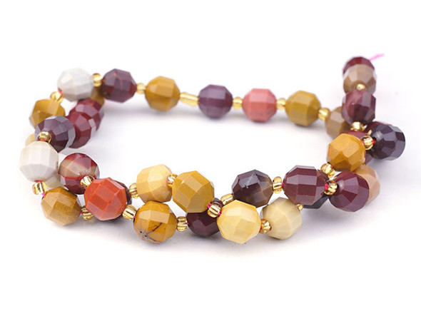 Energize your designs with this Dakota Stones mookalite faceted 8mm energy prism bead strand. The beads on this strand feature a faceted cut helping them catch the light. This strand features spacers between each of the beads, so you could use it as-is, or string the beads into a design. Mookaite is a variety of Jasper in colors of red, burgundy, pink, mauve, purple, yellow and white. It takes its name from Mooka Creek, near the Kennedy Ranges of Australia, the only region in the world where the stone is found.  Because gemstones are natural materials, appearances may vary from piece to piece.