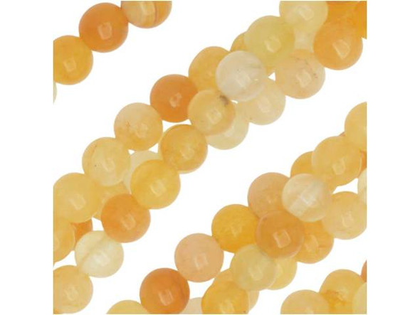 Honey color fills the Dakota Stones yellow Jade 4mm round beads. Available by the strand, these beads are perfectly round in shape, so they will work well in classic styles. They are small in size, making them excellent spacers or accents of color. This stone features an array of shades from deep oranges to creamy off white tones. Yellow Jade is the industry name for this natural serpentine. It has a Mohs hardness of 6-6.5.  Because gemstones are natural materials, appearances may vary from bead to bead. Each strand includes approximately 52 beads.