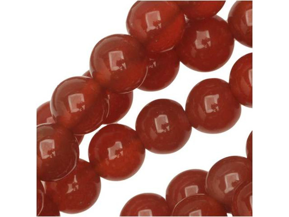 Bring delectable color to designs with the Dakota Stones 6mm carnelian round beads. Available by the strand, these beads feature a versatile round shape. They are versatile in size, so you can use them anywhere. Each bead displays a rich reddish-orange color. Carnelian is a translucent chalcedony or an A-grade agate that receives its beautiful red tints from iron oxides. Most deep red carnelian is heat treated to darken the material evenly. Carnelian is also known as the Mecca stone and natural agate. It has a Mohs hardness of 6.5. Metaphysical Properties: Often known as a motivation stone, carnelian is used for physical training and balancing body energy levels.Because gemstones are natural materials, appearances may vary from piece to piece. Carnelian is heat-treated to have a consistent color across the bead and strand. The color is very consistent. Each strand includes approximately 34 beads. 
