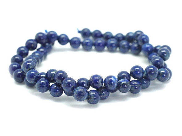 A dark elegance fills these lapis lazuli round beads from Dakota Stones. Available by the strand, these bold beads are spherical in shape and feature glittering golden color sprinkled over a dark blue background. Lapis lazuli is a semi-precious stone that contains primarily lazurite, calcite and pyrite. It was among the first gemstones to be worn as jewelry. Showcase these stunning gemstone beads in a necklace design. Metaphysical Properties: Lapis lazuli is said to enhance insight, intellect and awareness. Because gemstones are natural materials, appearances may vary from bead to bead.