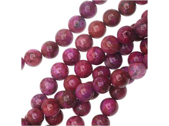 You'll love the fun color of these Dakota Stones beads. They feature deep and vibrant pink color filled with swirling style. These round beads would look excellent in matching necklace and bracelet sets. Mexican crazy lace agate is normally an opaque white gemstone with swirling patterns, but these beads are color enhanced with pink coloring to emphasize these beautiful patterns. Color enhancing is common amongst agates to make them fashionably relevant. They have a Mohs hardness of 6.5-7. Metaphysical Properties: Often called the happy stone, crazy lace agate promotes laughter and optimism. Because gemstones are natural materials, appearances may vary from bead to bead. Each strand includes approximately 24 beads.