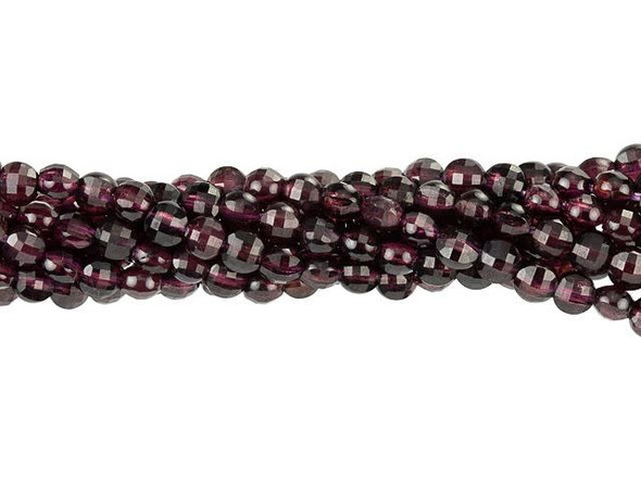 Keep your style sophisticated with these Dakota Stones purple garnet beads. These small gemstone beads feature a circular shape with a puffed edge and a checkerboard faceted face. The surface catches the light in a multitude of directions. The stringing hole is wide enough to use with 20 gauge wire. Use these small beads as accents of color and shine in all kinds of jewelry projects. They feature a deep wine purple color. Metaphysical Properties: Garnet is said to be a stone that utilizes creative energy. Because gemstones are natural materials, appearances may vary from piece to piece. Each strand includes approximately 99 beads.