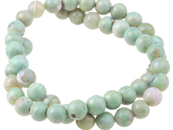 A beautiful blend of earthly color fills these green terra agate beads from Dakota Stones. These beads feature a mix of greenish-blue and brown, creating patterns like miniature Earths with the brown spaces like continents in the vast ocean. Terra agate is a form of chalcedony made of quartz. These beads are treated and dyed agate. Because gemstones are natural materials, appearances may vary from piece to piece.