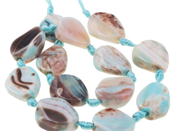 A beautiful blend of earthly color fills these terra agate beads from Dakota Stones. These beads feature a mix of greenish-blue and brown, creating Earth-like patterns with the brown spaces like continents in the vast ocean. Terra agate is a form of chalcedony made of quartz. These beads are treated and dyed agate. Because gemstones are natural materials, appearances may vary from piece to piece.