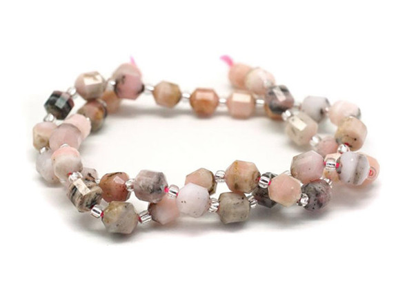 Energize your designs with this Dakota Stones pink opal faceted 6mm energy prism bead strand. The beads on this strand feature a faceted cut helping them catch the light. This strand features spacers between each of the beads, so you could use it as-is, or string the beads into a design. Pink Opal is a variety of non to precious opal, meaning that it has lustre and some translucency without the fire or color play associated with precious opal varieties. Pink Opal naturally occurs in shades of extremely pale to deeper pink. Metaphysically, Pink Opal is said to aid in the productivity of new endeavors. Because gemstones are natural materials, appearances may vary from bead to bead.