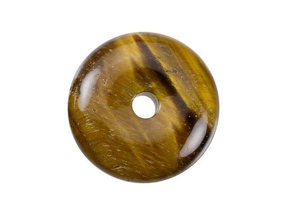 A magical look can be yours with this gemstone pendant from Dakota Stones. This tiger eye pendant features a round donut shape with a hole at the center. You can create your own unique bail for this pendant or simply slide a silk ribbon right through. There are lots of fun ways you can showcase this piece in your designs. This pendant features a golden brown color with a magical chatoyancy that reflects bands of light. Metaphysical Properties: Tiger eye can be used to balance pessimistic behavior and it dissolves negative energy and thought patterns. It has also been used to enhance wealth and vitality.Because gemstones are natural materials, appearances may vary from bead to bead.Diameter 25mm, Opening Diameter 4mm