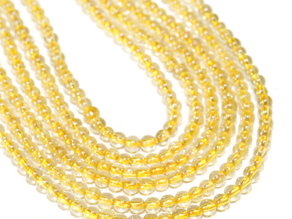 Bring the shine of gemstones to your designs with these Golden Rhutilated Quartz beads from Dakota Stones. These beads feature a classic round shape and a clear color with hints of gold. Golden Rutilated Quartz is a silicon dioxide mineral with unique needle-like inclusions of Rutile. These &ldquo;needles&rdquo; usually appear golden, but can also appear silver, red, copper, or black and can be distributed randomly or in bundles or star-like formations. Rutile is the mineral name for natural crystals of titanium dioxide, which may contain iron oxide.  Because gemstones are natural materials, appearances may vary from piece to piece.