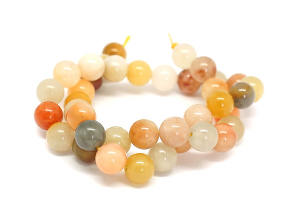 You&rsquo;ll love this Dakota Stones jade rainbow 10mm round bead strand. These beads feature a classic round shape and a variety of orange, yellow, white and even grey colors. Their 10mm size will make them stand out in your projects. Because gemstones are natural materials, appearances may vary from piece to piece.