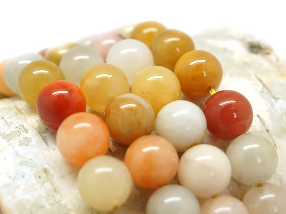 You&rsquo;ll love this Dakota Stones jade rainbow 10mm round bead strand. These beads feature a classic round shape and a variety of orange, yellow, white and even grey colors. Their 10mm size will make them stand out in your projects. Because gemstones are natural materials, appearances may vary from piece to piece.