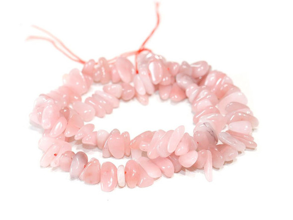 Bring colorful style to your designs with these guava quartz chip beads from Dakota Stones. Named for the color of the flesh of guava fruit, guava quartz features a pink color.  It is also said to represent love. These beads feature irregular chip shapes, perfect for organic styles. Layer them into necklaces, bracelets, and even earrings. Because gemstones are natural materials, appearances may vary from piece to piece. 