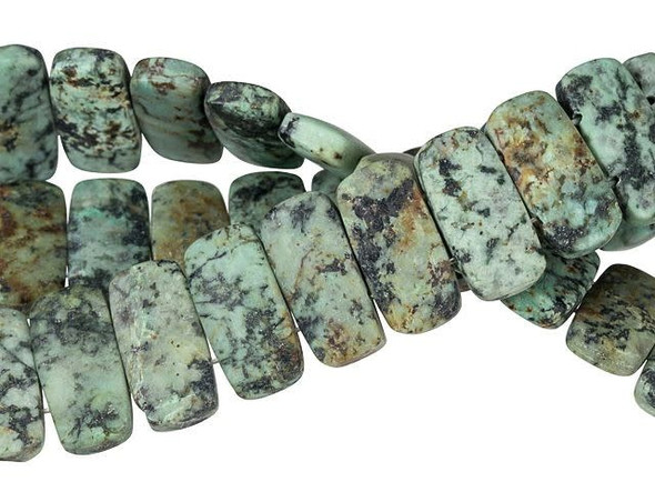 Add unique dimension to designs with these Dakota Stones beads. These beads feature a bold rectangular shape. Two stringing holes are drilled through each bead, so you can use these beauties in multi-strand creations. They make excellent watch bands. They feature turquoise blue and green colors with a black matrix and a muted matte finish. This stone is mined in Africa and is actually a type of spotted teal Jasper rather than turquoise. It is given its industry name because the matrix structure and shade is similar to that of turquoise. Metaphysical Properties: Often called the stone of evolution, African Turquoise Jasper encourages growth and development not only in the body, but in the mind. Some spiritualists believe that it will attract money to the wearer.Because gemstones are natural materials, appearances may vary from bead to bead. Each strand includes approximately 20 beads.