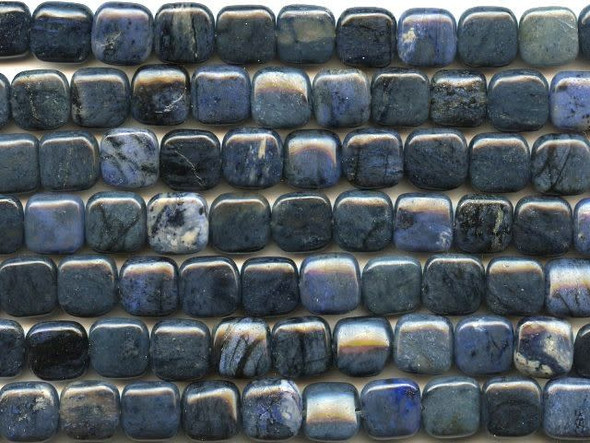 Create contemporary, sophisticated style with the dumortierite 12mm square beads from Dakota Stones. These beads feature a slightly puffed square shape and they would look great in necklaces, bracelets or even dangling in a pair of earrings. Each bead features a dark blue color. Dumortierite is a fibrous variably colored aluminum boro-silicate mineral. They crystals are vitreous and vary in color. Metaphysical Properties: Known as the "Stone of Order," dumortierite is said to help boost intellectual perception and to help in becoming more organized.Because gemstones are natural materials, appearances may vary from piece to piece. Each strand includes approximately 16 beads. 