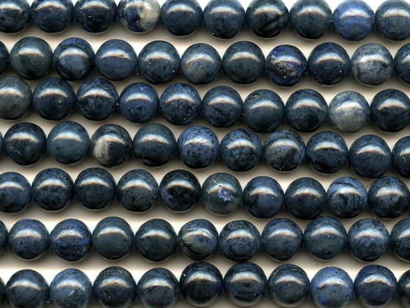 Bold blue colors fills the dumortierite 8mm round beads from Dakota Stones. These beads feature a round shape for a classic look that works in any style. Each bead shines with a dark blue color full of depth. The 8mm size always looks lovely in bracelets and necklaces, so you can make a charming jewelry set with these beads. Dumortierite is a fibrous variably colored aluminum boro-silicate mineral. They crystals are vitreous and vary in color. Metaphysical Properties: Known as the "Stone of Order," dumortierite is said to help boost intellectual perception and to help in becoming more organized.Because gemstones are natural materials, appearances may vary from piece to piece. Each strand includes approximately 24 beads. 