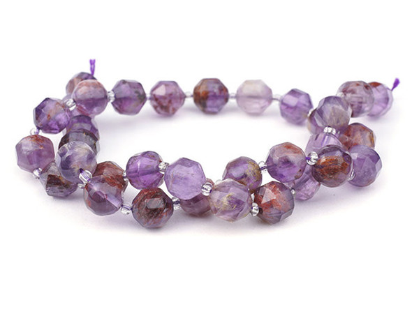 Energize your designs with this Dakota Stones cacoxenite faceted 10mm energy prism bead strand. The beads on this strand feature a faceted cut helping them catch the light. This strand features spacers between each of the beads, so you could use it as-is, or string the beads into a design. Cacoxenite is the trade name for this naturally occurring blend of seven stone types. This stone, often called the "Super Seven" or "Melody Stone" contains amethyst, clear quartz, smoky quartz, lepidocrosite, goethite, and rutile. These versatile round beads are perfect for any kind of jewelry design, from necklaces and bracelets to earrings. They feature star cut facets that really catch the light. You'll love the smoky purple and brown colors. Metaphysical Properties: Cacoxenite is said to be a healing and harmonizing stone. Because gemstones are natural materials, appearances may vary from bead to bead.