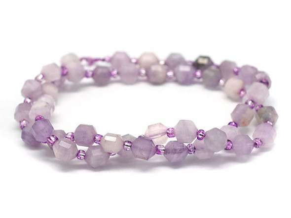 Energize your designs with this Dakota Stones lavender amethyst faceted 6mm energy prism bead strand. The beads on this strand feature a faceted cut helping them catch the light. This strand features spacers between each of the beads, so you could use it as-is, or string the beads into a design. Amethyst forms in silica-rich liquids deposited in geodes and is generally found in clusters of crystal points. Metaphysical Properties: This stone's name is derived from the Greek word amethystos, meaning "not drunken." People of ancient times believed it to protect the wearer from drunkenness. Today, this gemstone is believed to promote happiness. Because gemstones are natural materials, appearances may vary from piece to piece.