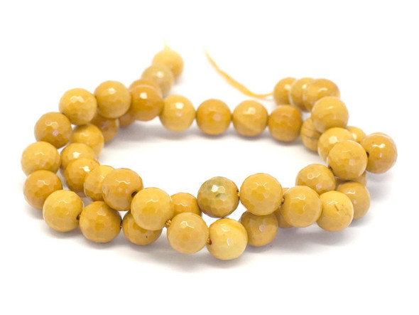 Bring sunny color to your designs with these yellow mookaite gemstone beads from Dakota Stones. These beads feature a warm yellow color and a faceted round shape. Mookaite is a variety of Jasper that takes its name from Mooka Creek, near the Kennedy Ranges of Australia, the only region in the world where the stone is found.  Because gemstones are natural materials, appearances may vary from piece to piece.